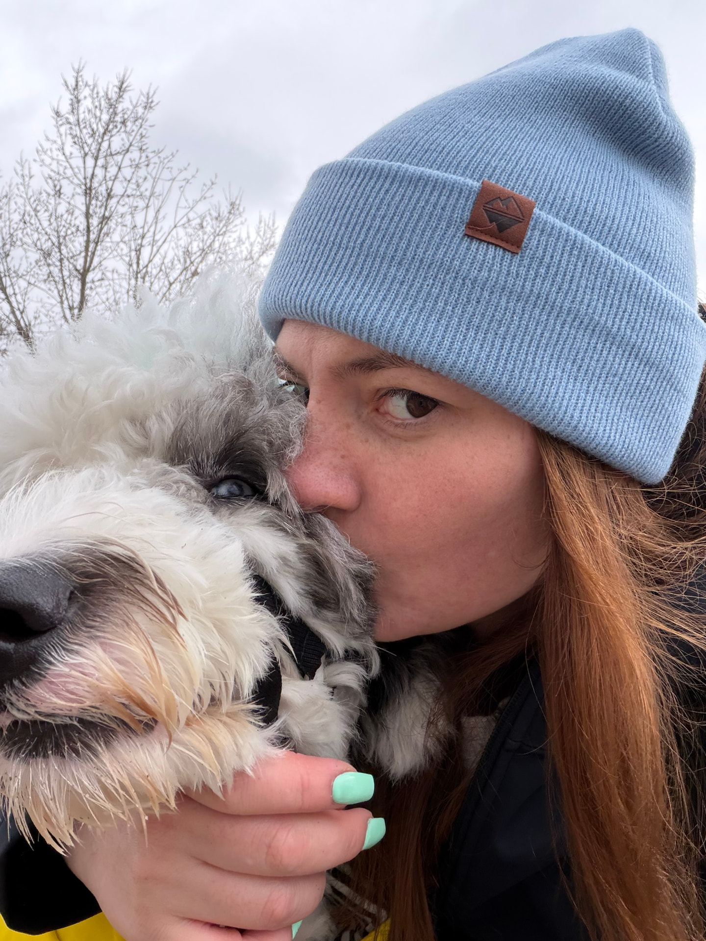 Felicia, groomer at Bark Salon, with a fluffy dog